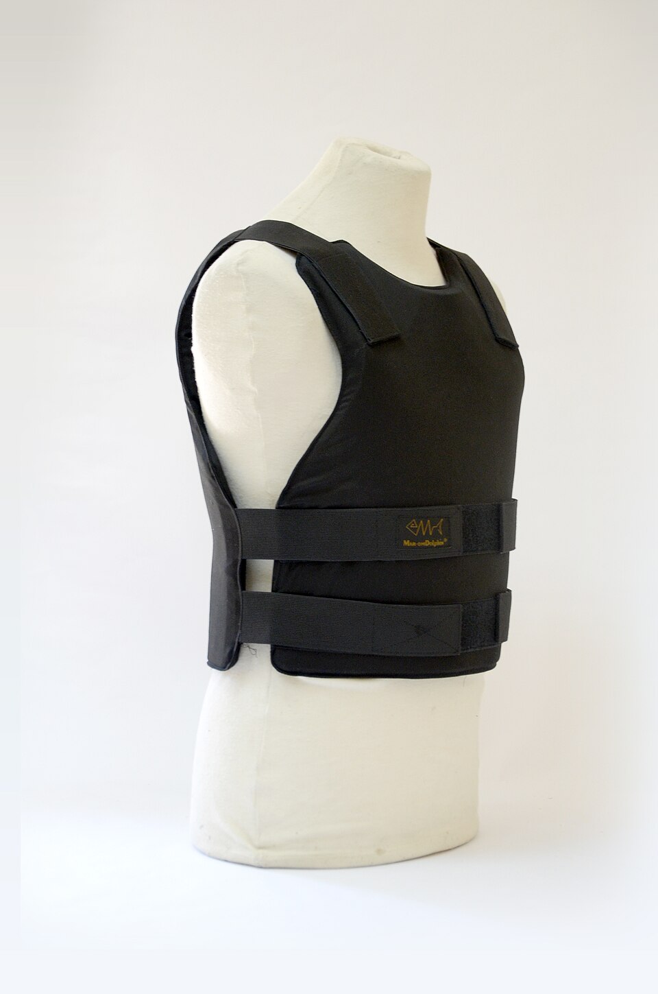 A black soft ballistic vest (NIJ Level IIIA) fitted on a plain cloth tailor's mannequin, three-quarter view, showing the shoulder straps and the two wide velcro waist bands that close the front and back panels