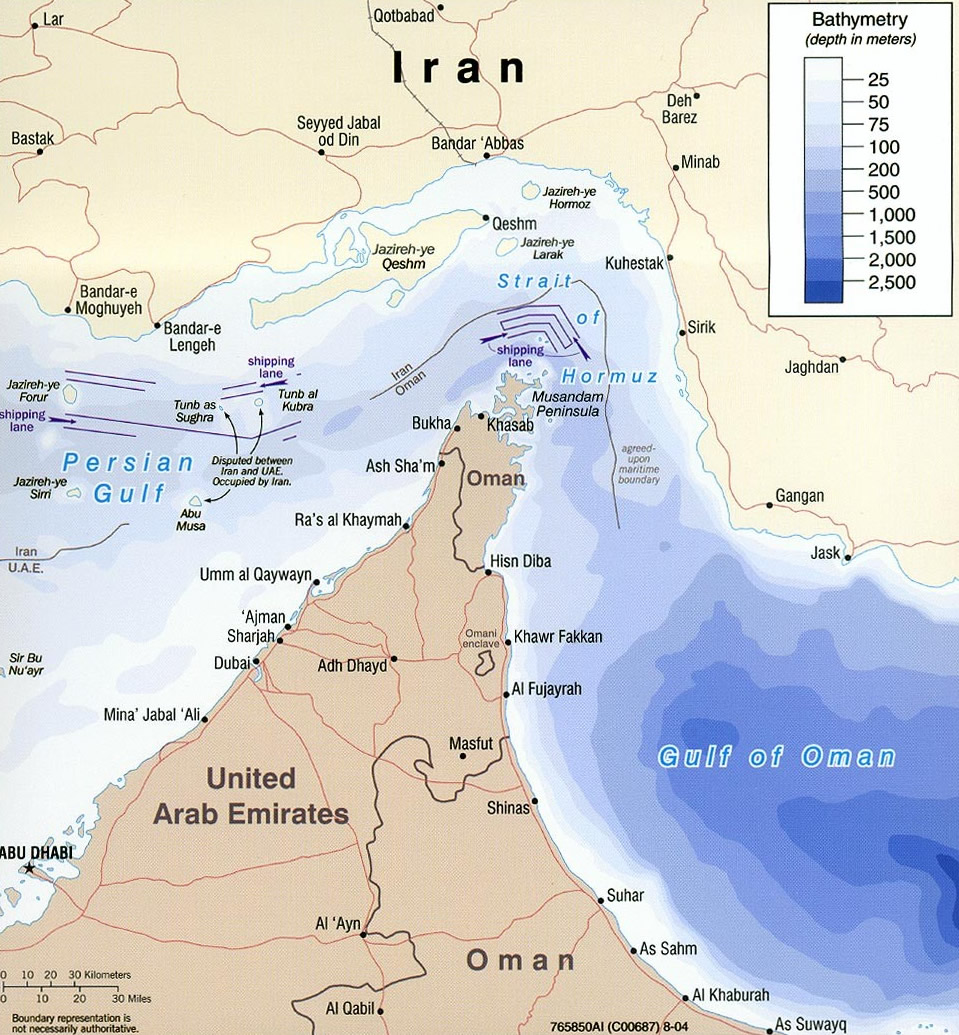 Bathymetric map of the Strait of Hormuz, showing the Persian Gulf narrowing between Iran and Oman's Musandam Peninsula and opening south-east into the Gulf of Oman, with the inbound and outbound shipping lanes marked