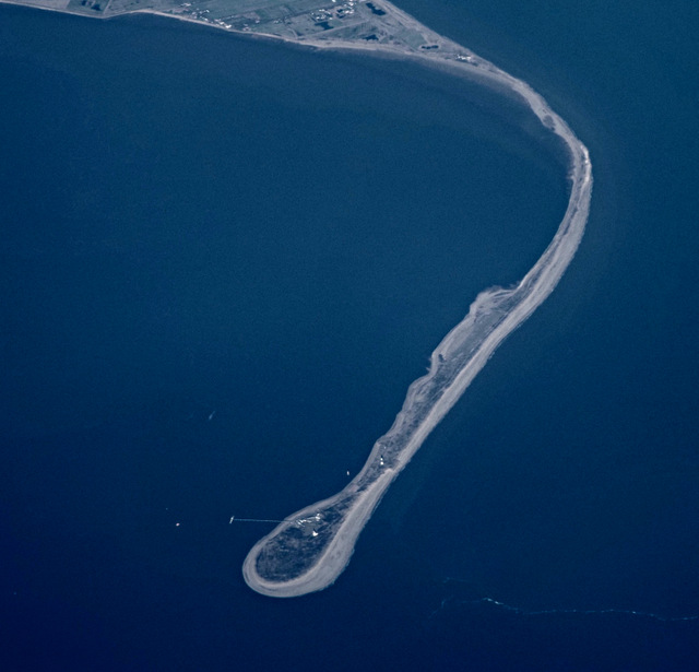 Aerial view of Spurn Point, a narrow curving ridge of sand reaching into the sea, joined to the mainland at one end and free at the other