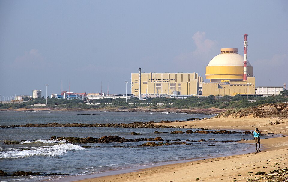 The Kudankulam nuclear power station on the Tamil Nadu coast, its domed reactor containment building and turbine hall seen across a sandy beach