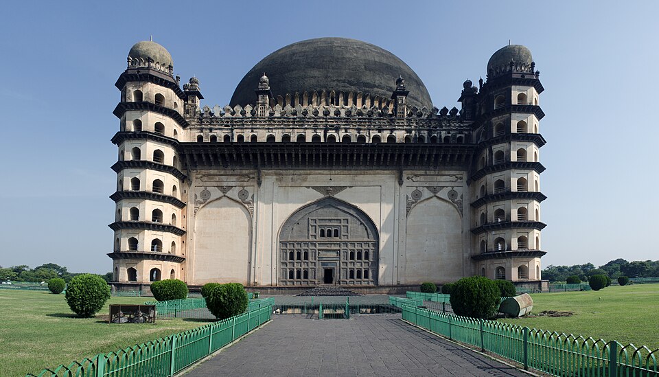 The Gol Gumbaz at Bijapur seen head-on: a cubical mausoleum crowned by an enormous hemispherical dome, with seven-storeyed octagonal towers at each corner