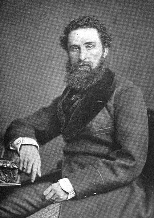 Seated black-and-white portrait of Robert Bulwer-Lytton, 1st Earl of Lytton, in a tweed suit with a full beard