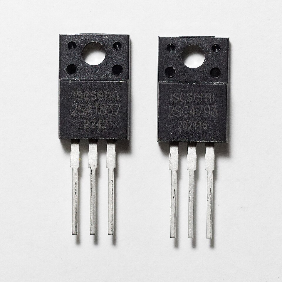 Two black-packaged bipolar transistors side by side, each with three metal leads