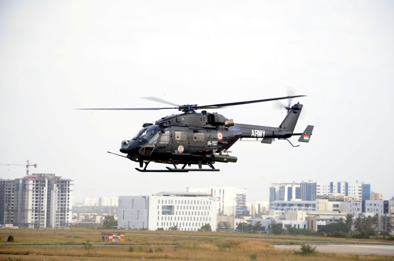 An Indian Army HAL Rudra helicopter in low flight, its nose turret and weapon pylons visible in profile