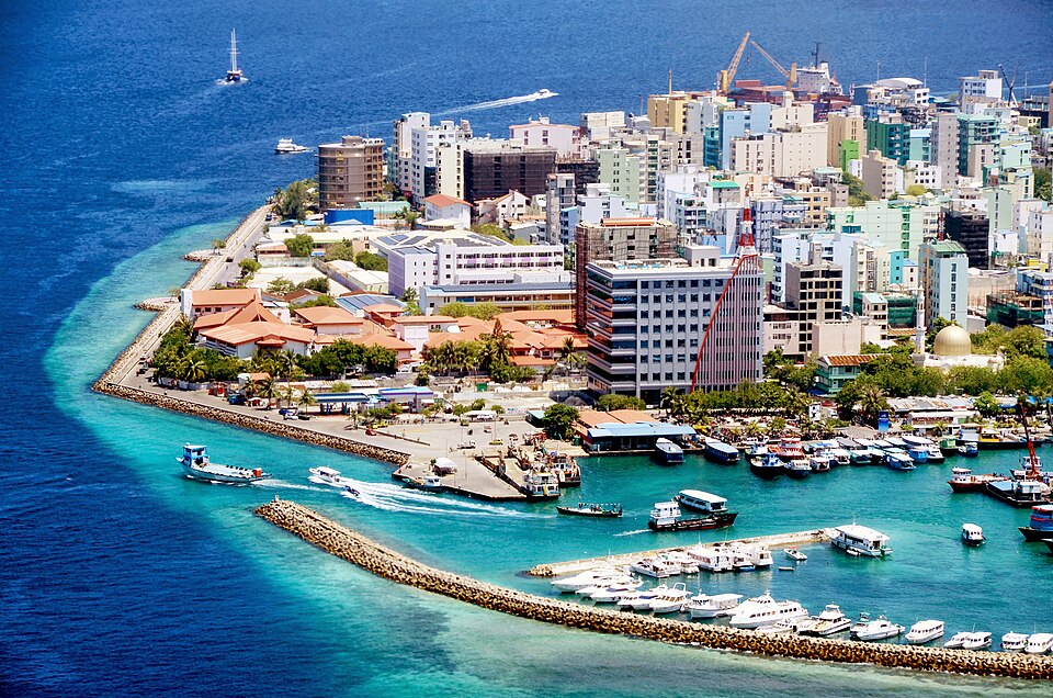 Aerial view of Male, the densely built island capital of the Maldives, ringed by a seawall and harbour full of boats