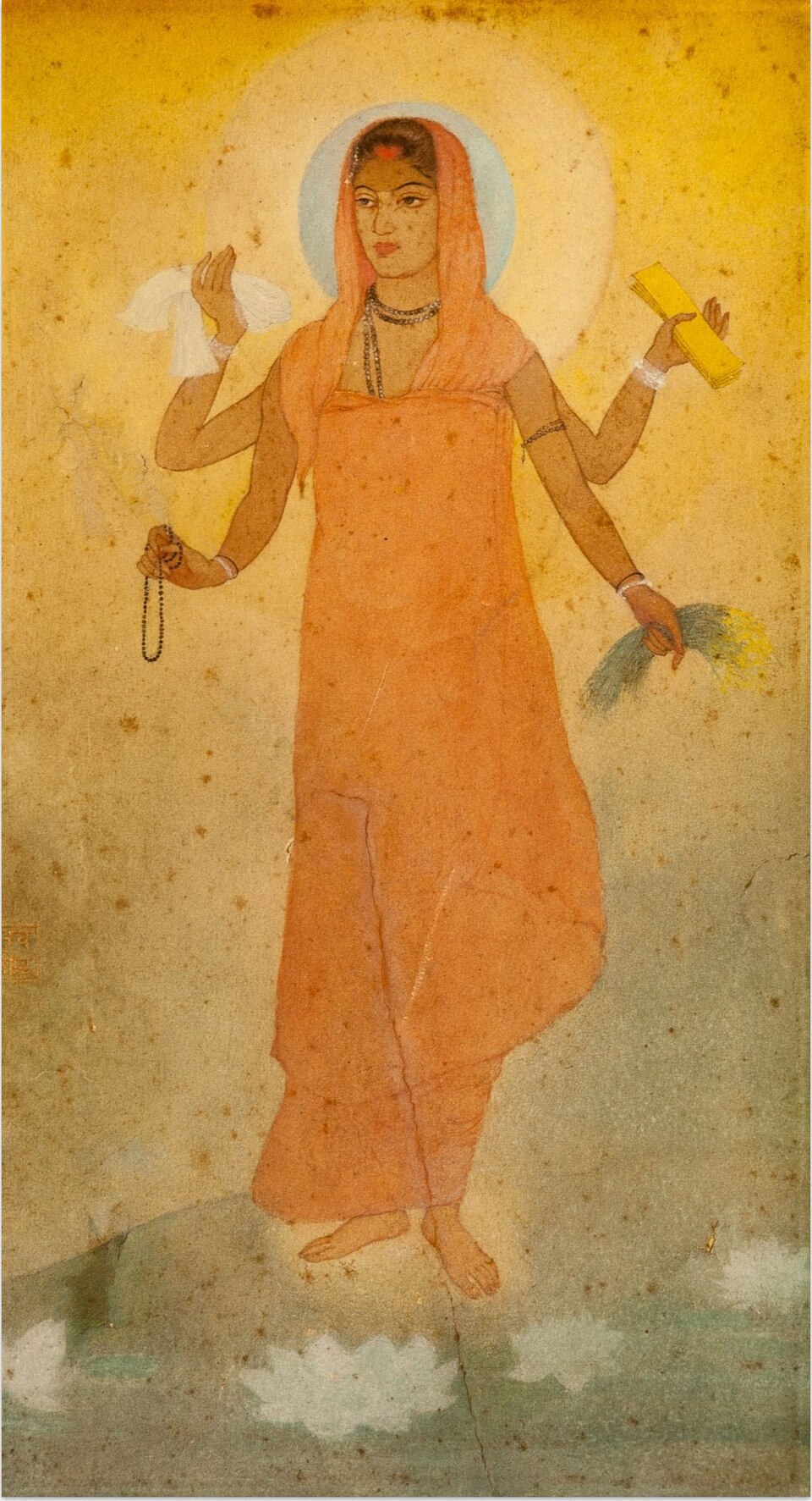 Abanindranath Tagore's watercolour of a four-armed woman in a saffron sari holding a book, sheaf of paddy, cloth and rosary, haloed against a golden ground
