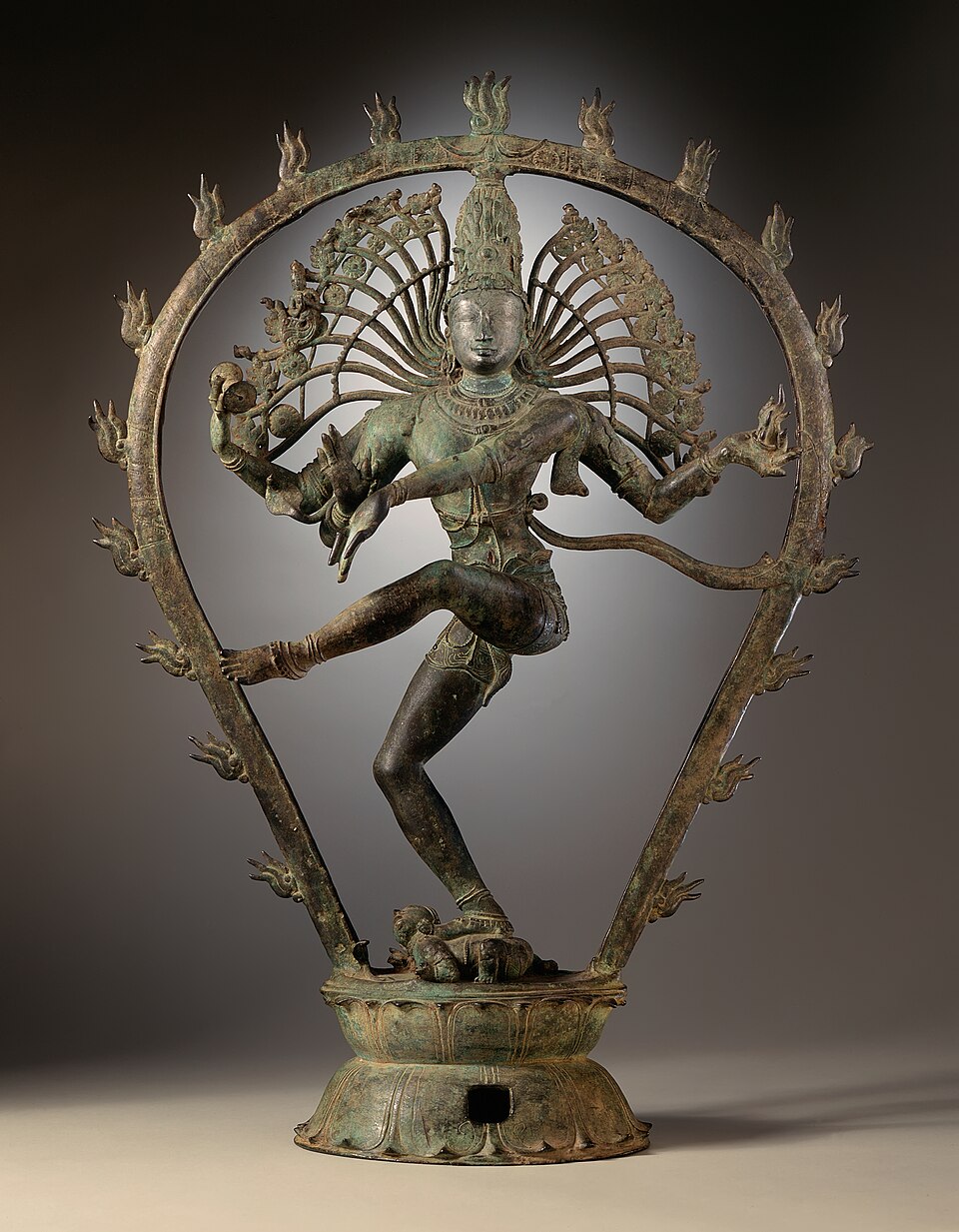 A Chola bronze of Shiva as Nataraja dancing within a ring of flames, balanced on the right leg over the crouching dwarf Apasmara
