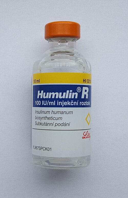 A 10 ml glass vial of human insulin injection, 100 IU per ml, with an orange flip-top seal, its label reading Insulinum humanum biosyntheticum