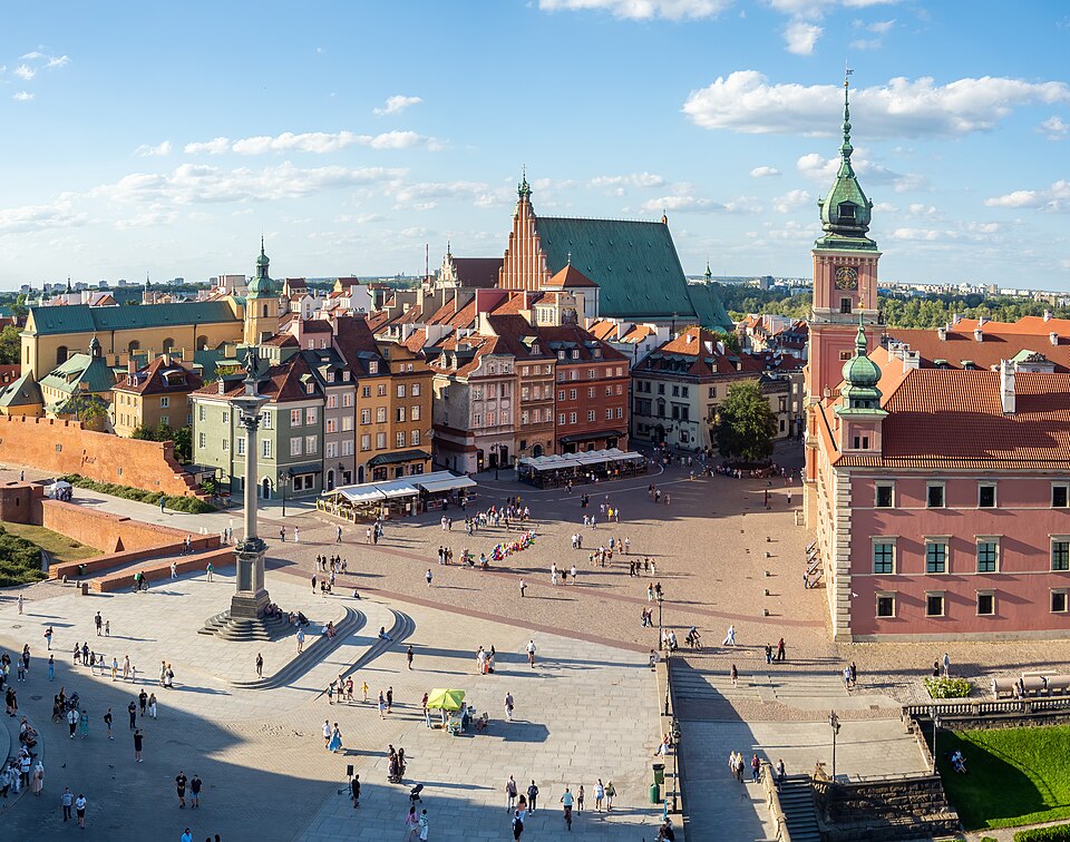 Castle Square in Warsaw's Old Town, with Sigismund's Column in front of the pink Royal Castle and rows of coloured townhouses behind