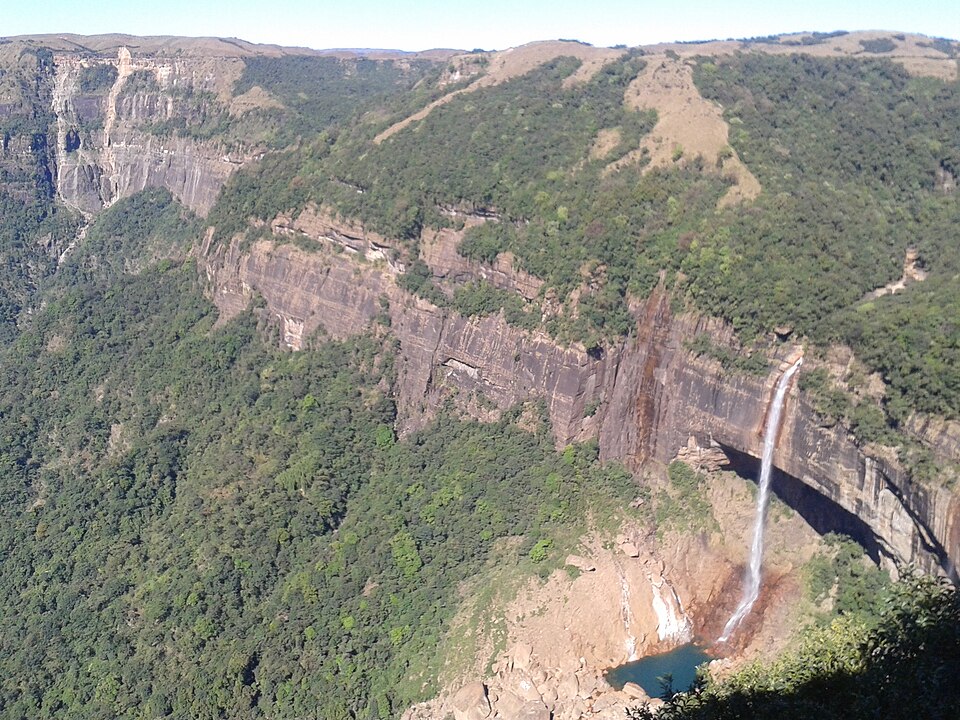 A waterfall dropping down the forested cliffs of the Khasi Hills escarpment at Mawsynram, Meghalaya.
