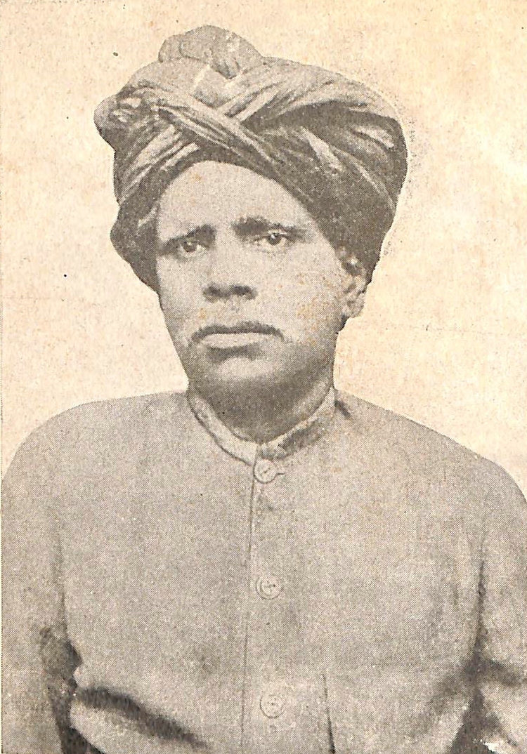 An old sepia photograph of the Telugu social reformer Kandukuri Veeresalingam, wearing a large wrapped turban and a buttoned coat.