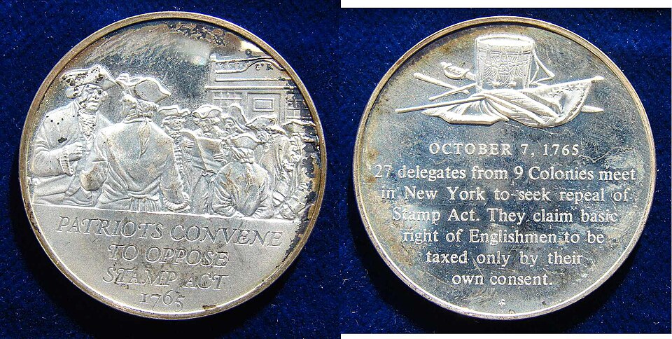 Obverse and reverse of a silver commemorative medal: one face shows colonial delegates gathering under the legend 'Patriots convene to oppose Stamp Act 1765', the other carries an inscription recording that on 7 October 1765 twenty-seven delegates from nine colonies met in New York to seek repeal of the Stamp Act.