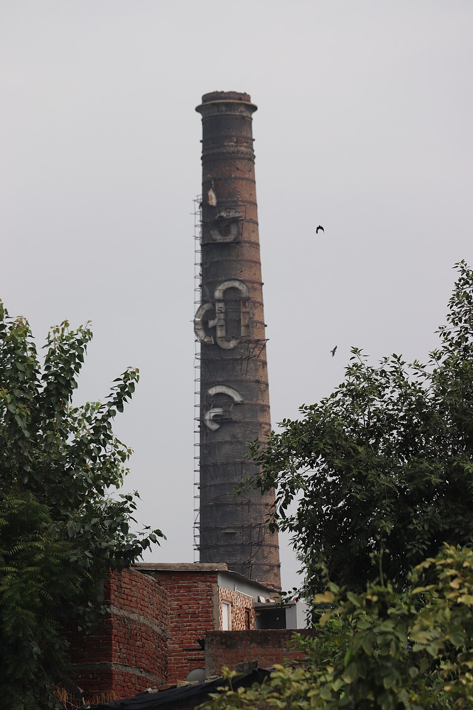 The tall brick chimney of the historic Calico textile mill in Ahmedabad, Gujarat.