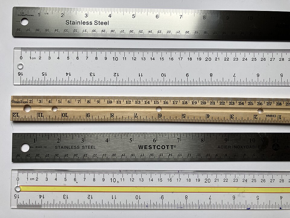 Steel and wooden rulers marked in centimetres and millimetres.