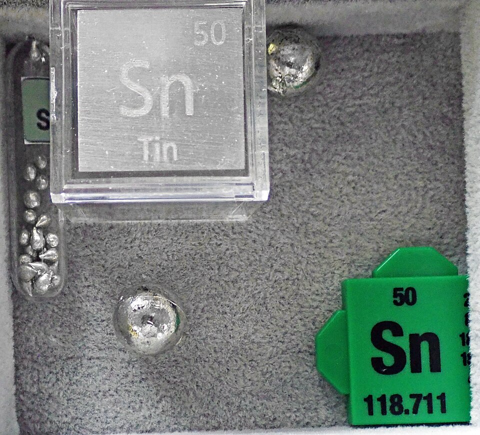 Samples of the pure element tin (Sn), labelled with its atomic number 50.