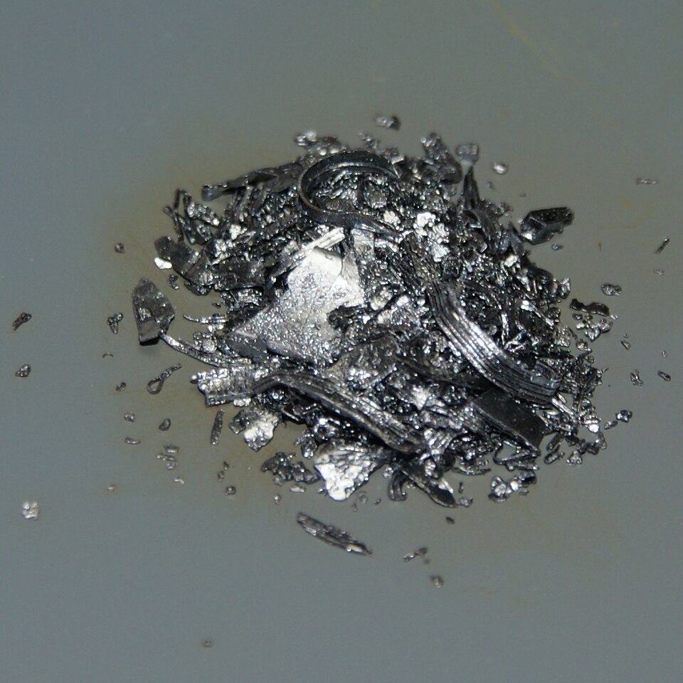 Shiny violet-black solid iodine crystals.