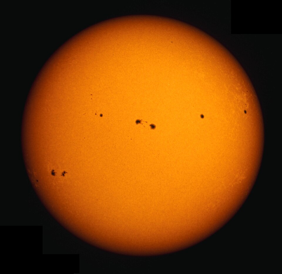 White-light photograph of the Sun's disc showing two large sunspots.