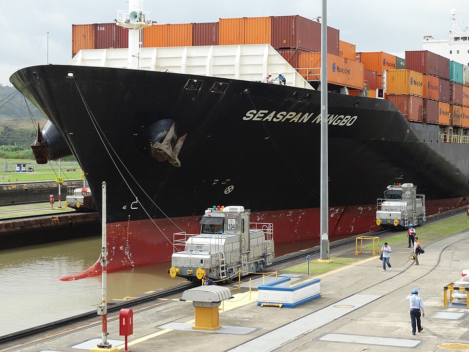 A container ship being towed by mule locomotives through the Miraflores Locks of the Panama Canal