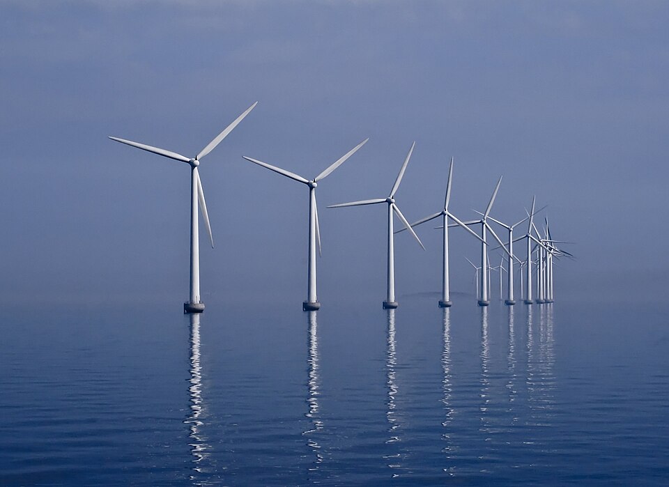 The curved row of white offshore wind turbines of the Middelgrunden wind farm off Copenhagen, Denmark