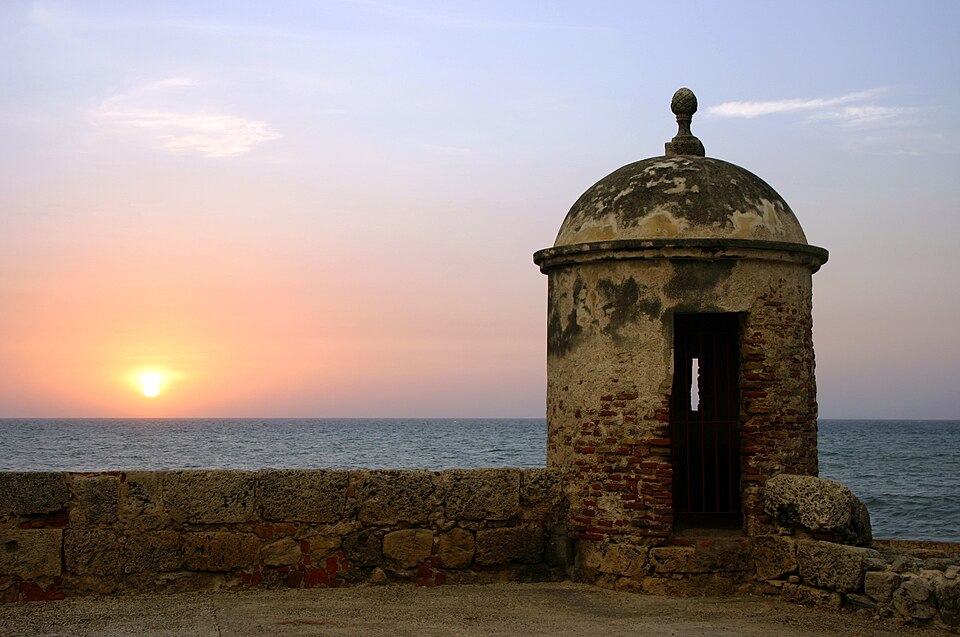 A stone sentry box on the fortified sea walls of Cartagena de Indias, Colombia, at sunset