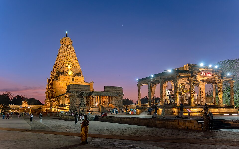 Brihadishvara (Rajarajeshvara) Chola temple at Thanjavur illuminated at dusk, its towering vimana rising over the courtyard