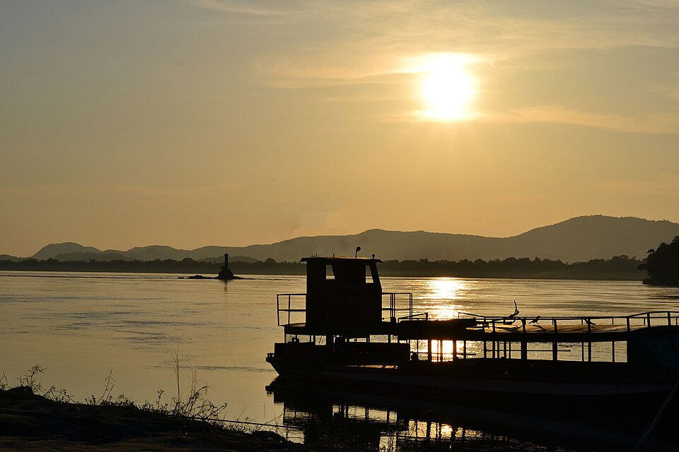 The wide Brahmaputra river at Guwahati, Assam, at sunset with a ferry moored in the foreground