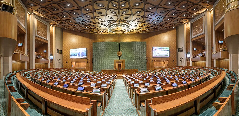 The horseshoe-shaped Lok Sabha chamber with tiered member desks facing the Speaker's chair
