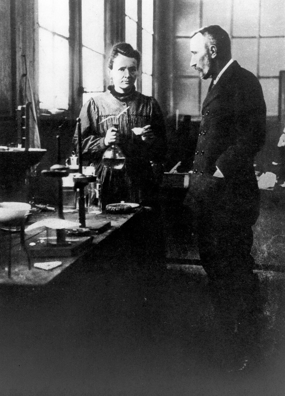 Marie Curie at her laboratory bench beside Pierre Curie (historical photograph)