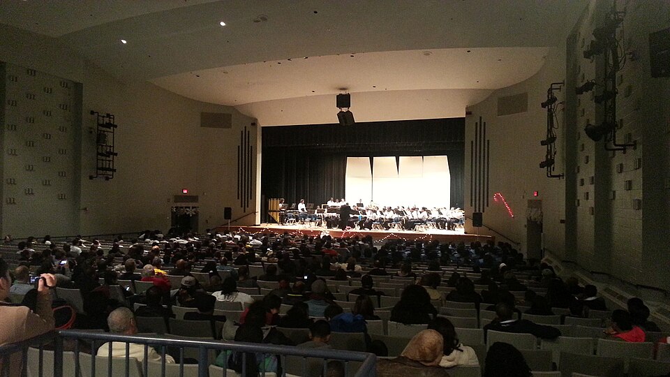 Interior of a large auditorium concert hall with rows of seats facing the stage