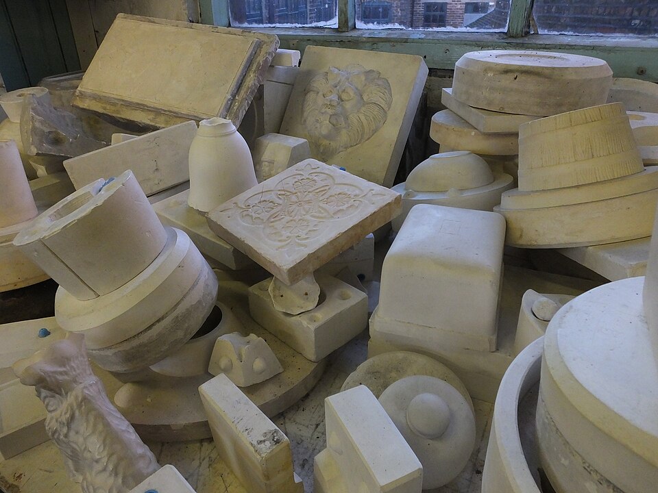 Set white Plaster of Paris casts and moulds stacked in a workshop