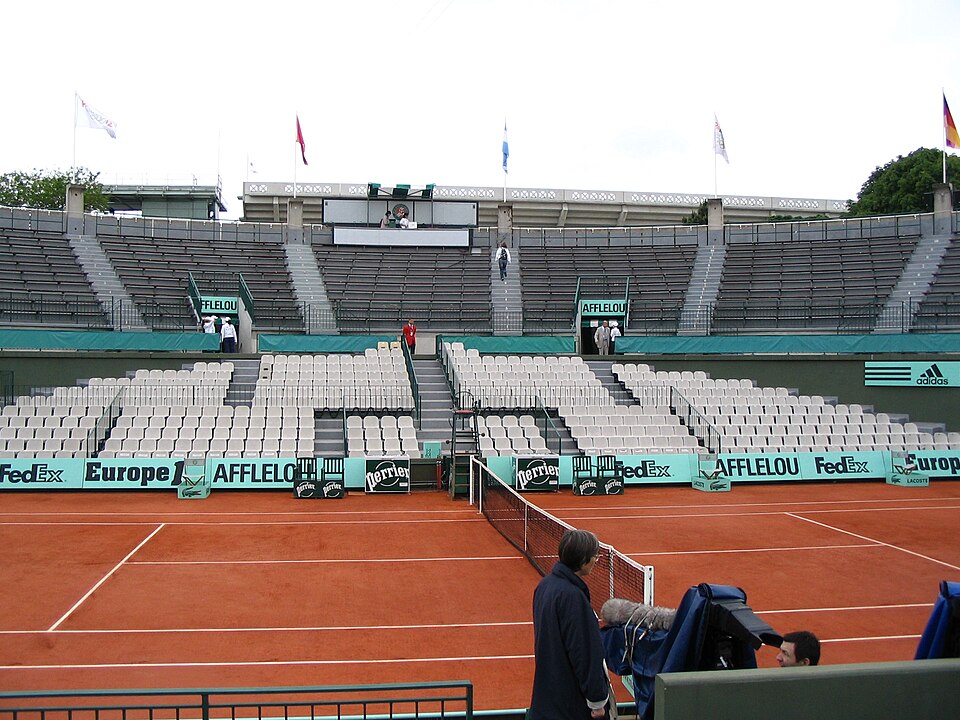 Red clay show court and empty stands at Roland Garros, venue of the French Open in Paris