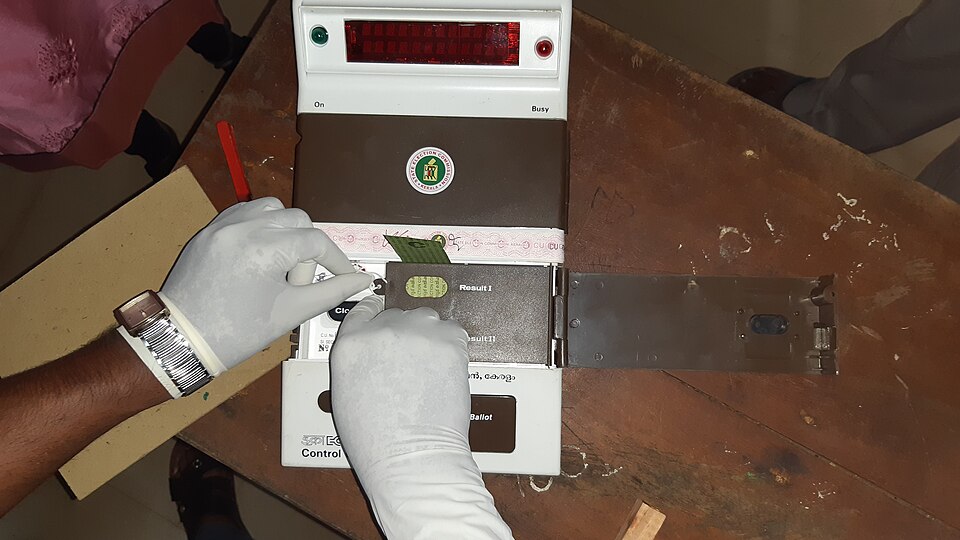 The control unit of an Indian Electronic Voting Machine bearing the Election Commission logo
