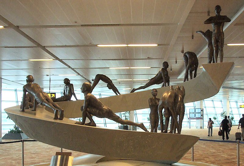 The bronze Surya Namaskar sculpture at Delhi airport Terminal 3 depicting the twelve yoga poses