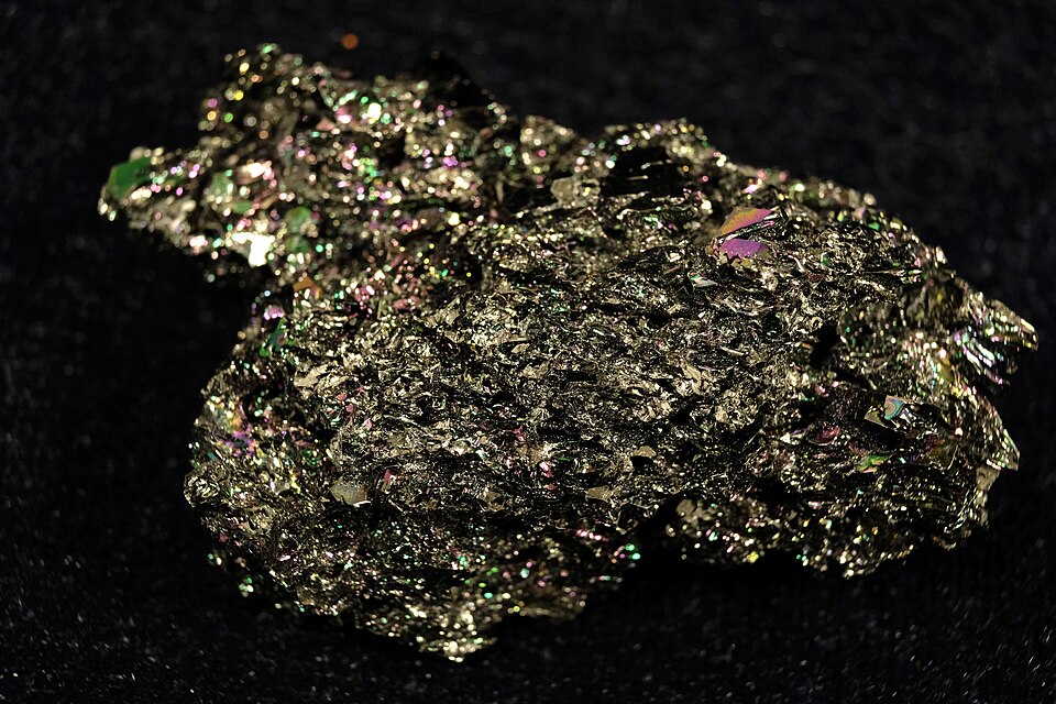 An iridescent crystalline lump of silicon carbide (carborundum), a very hard covalent abrasive