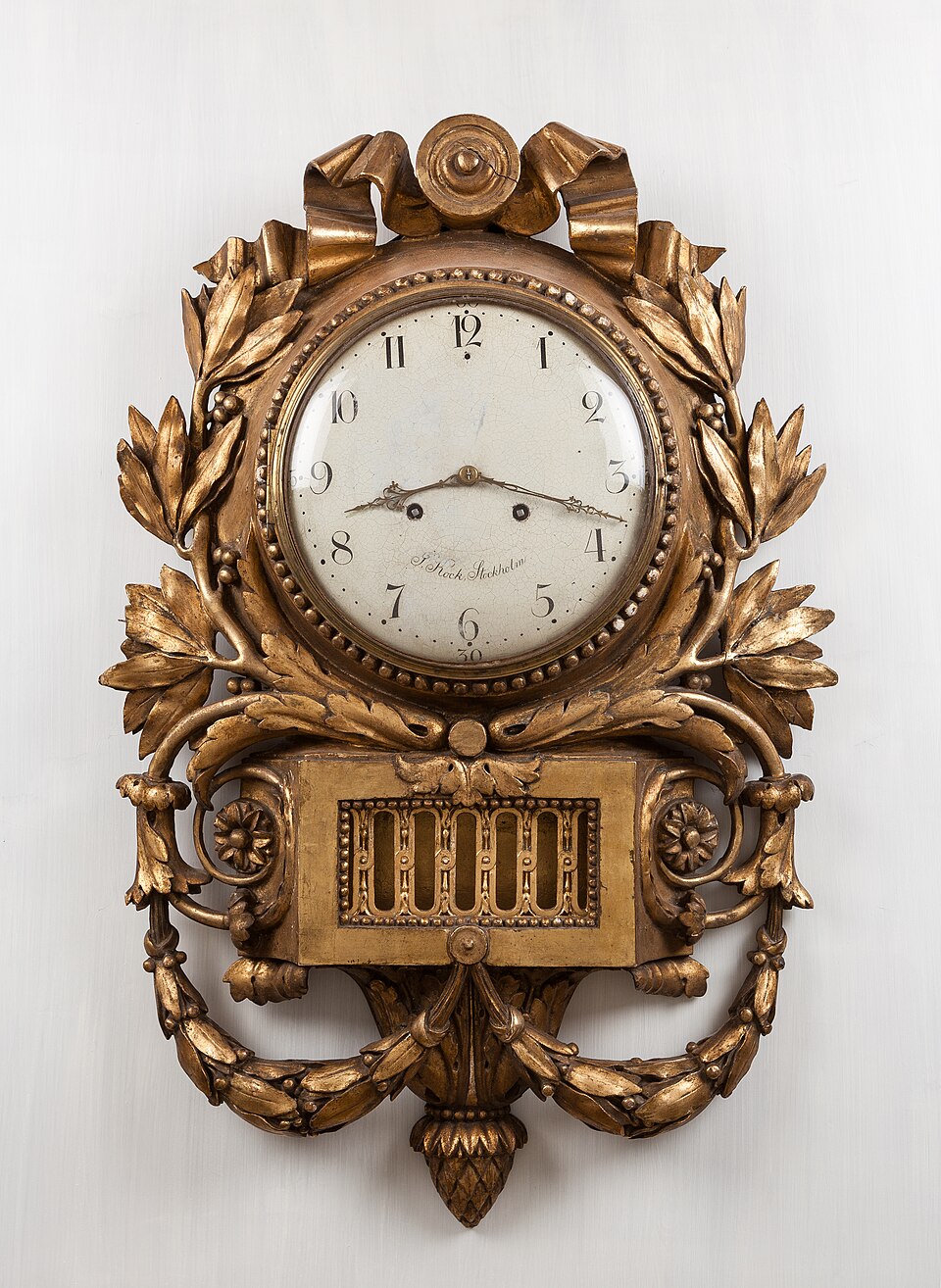 An antique pendulum wall clock, whose swinging pendulum keeps time