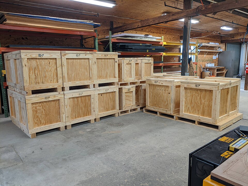 Wooden plywood shipping crates resting on a floor