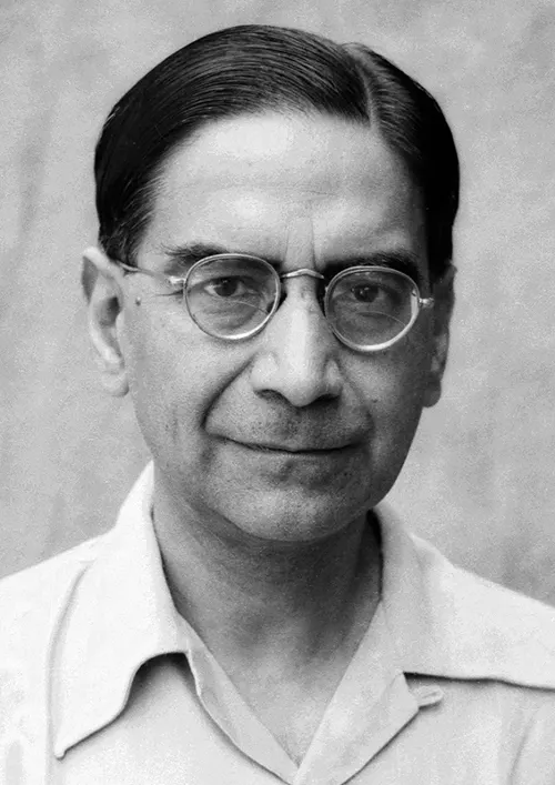 Black-and-white portrait photograph of the statistician P.C. Mahalanobis, a middle-aged man in round spectacles and an open-collared white shirt.
