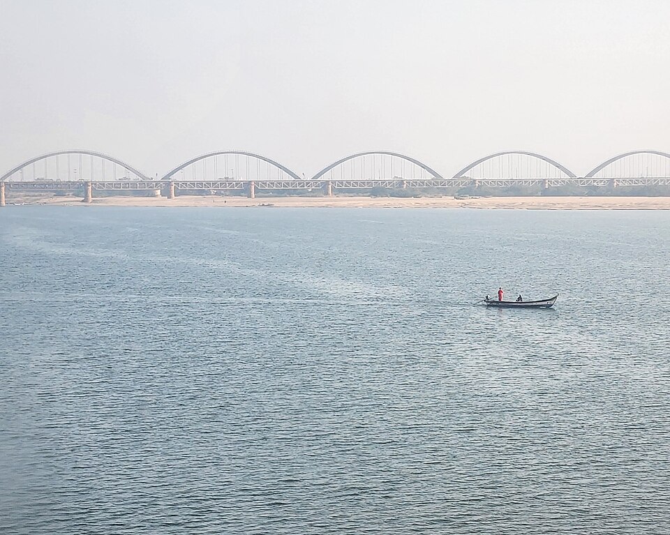 The wide Godavari river at Rajahmundry with the arched rail bridge in the distance