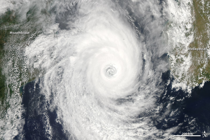 Satellite view of a mature tropical cyclone over the ocean, showing a clear central eye and spiralling rainbands