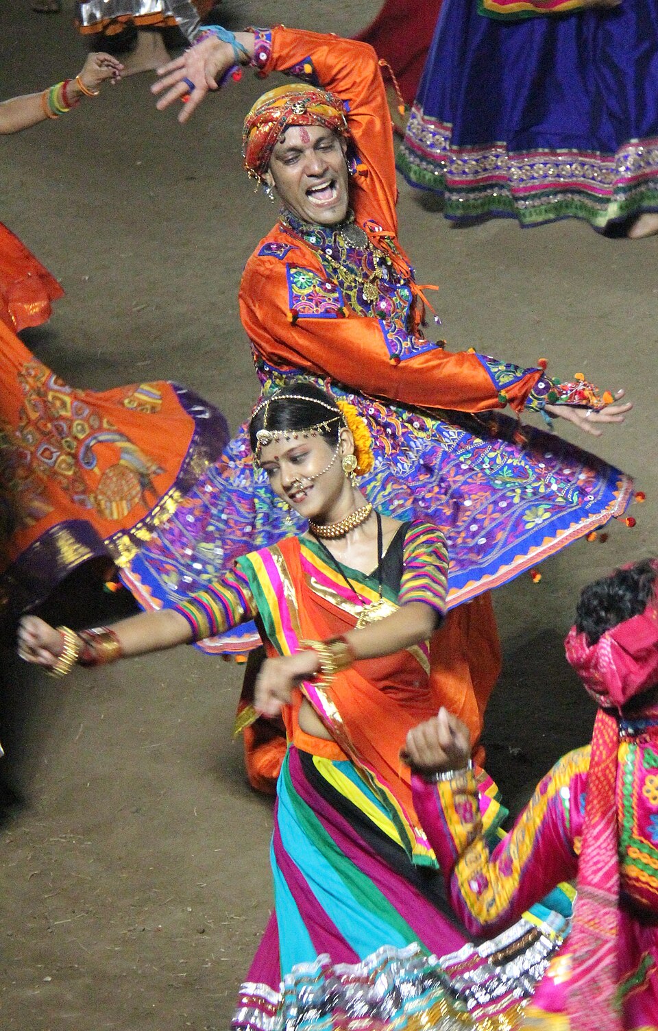 Dancers in bright traditional Gujarati dress performing Garba during Navratri