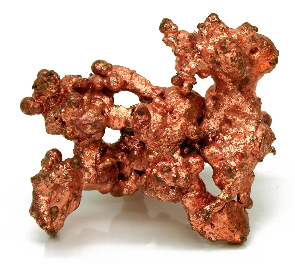 A specimen of native copper — naturally occurring metallic copper with a reddish crystalline surface