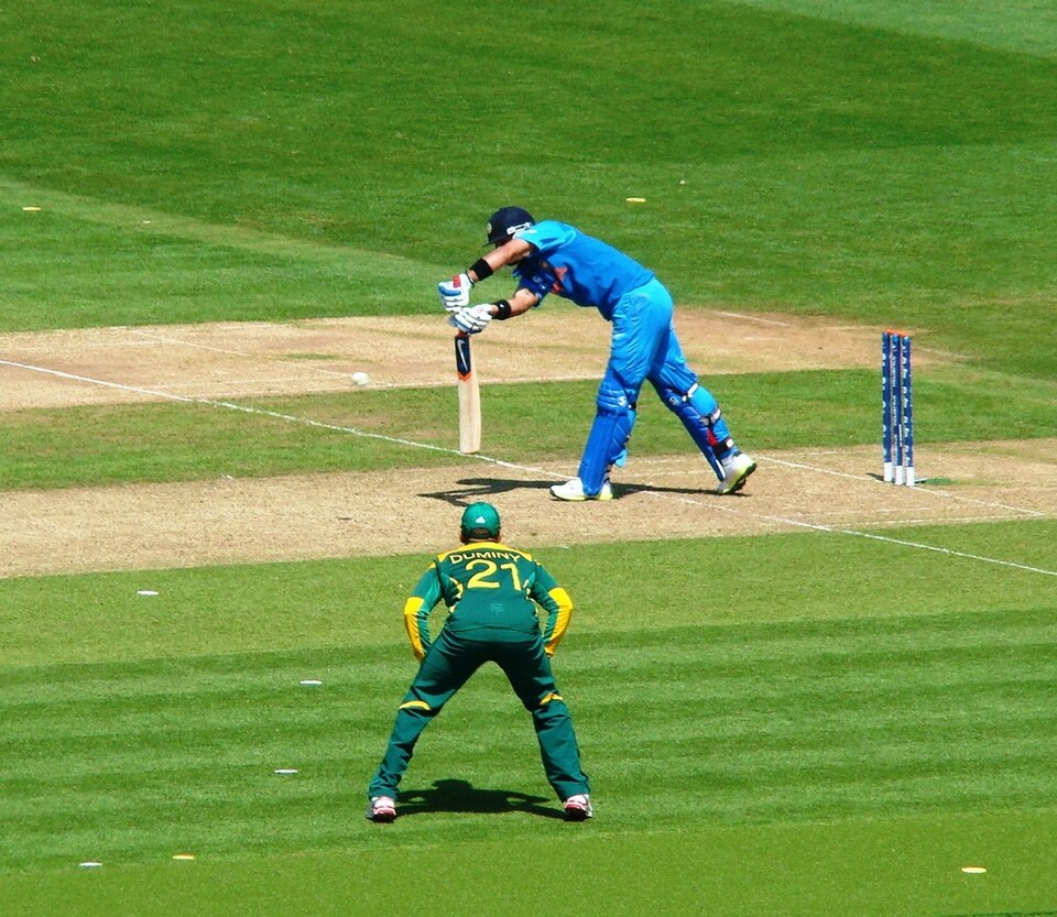 Virat Kohli batting for India, playing a shot in his blue kit