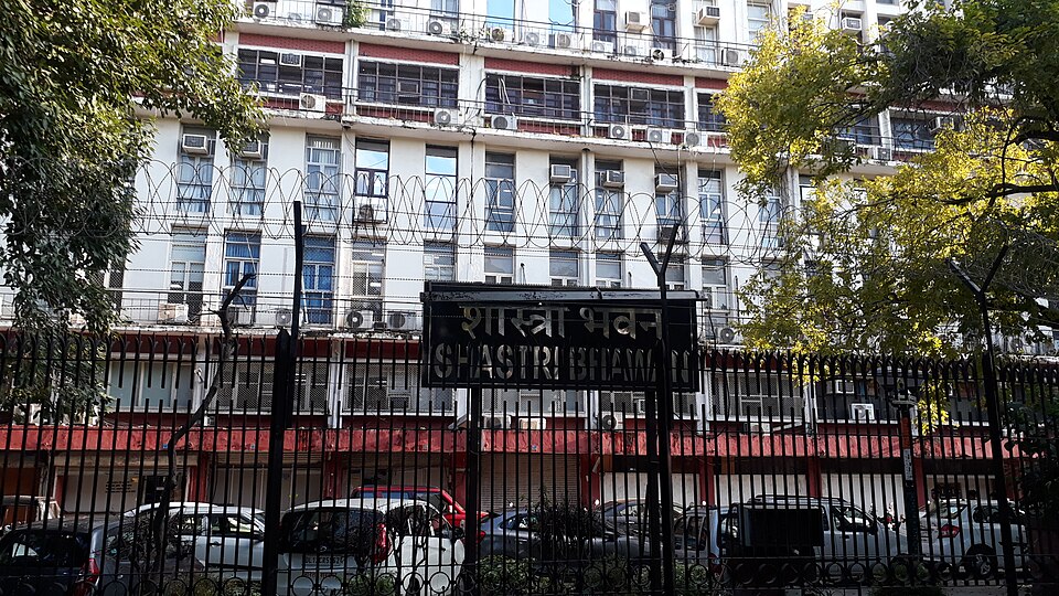 The multi-storey Shastri Bhawan government building in New Delhi, its gate name board reading Shastri Bhawan in Hindi and English