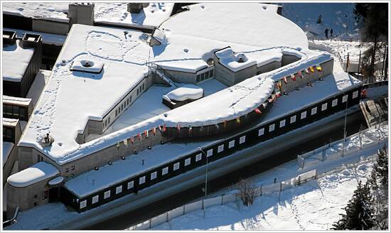 Aerial view of the snow-covered Congress Centre in Davos, Switzerland, strung with flags during a World Economic Forum Annual Meeting