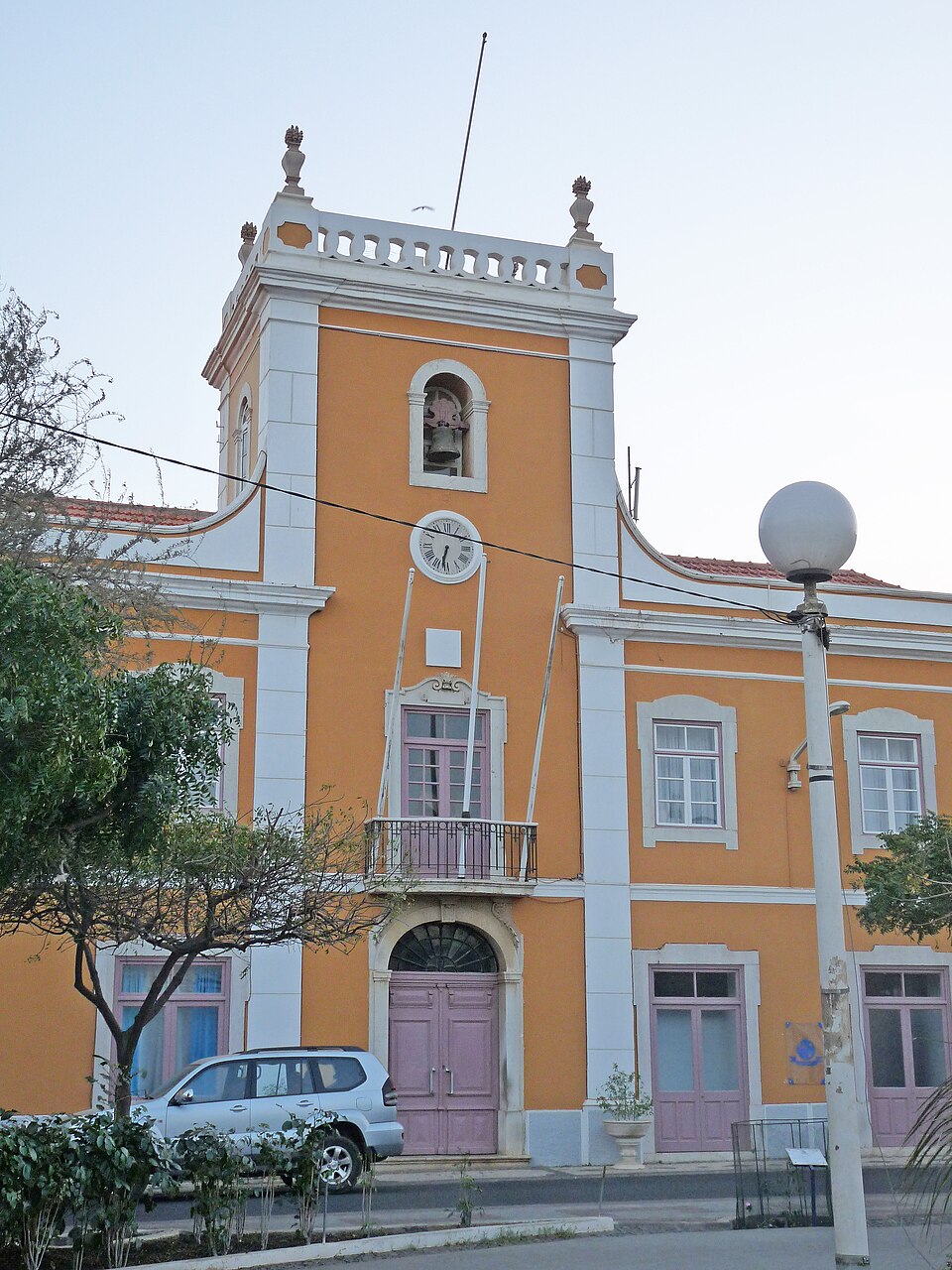 The colonial-era City Hall of Praia, a yellow-and-white building with a clock tower, bell and balustrade