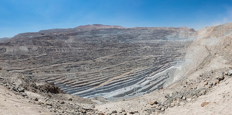 Panorama of the terraced benches of the Chuquicamata open-pit copper mine descending into a vast dry excavation in northern Chile