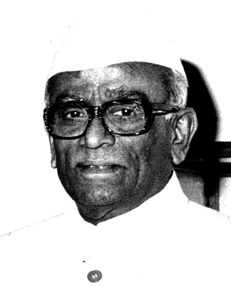 Black-and-white portrait of Neelam Sanjiva Reddy, an elderly man in thick-rimmed glasses and a white Gandhi cap