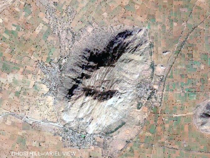 Satellite view of Dhosi Hill, a single rocky hill rising in isolation from a chequerboard of cultivated fields, with villages ringing its base