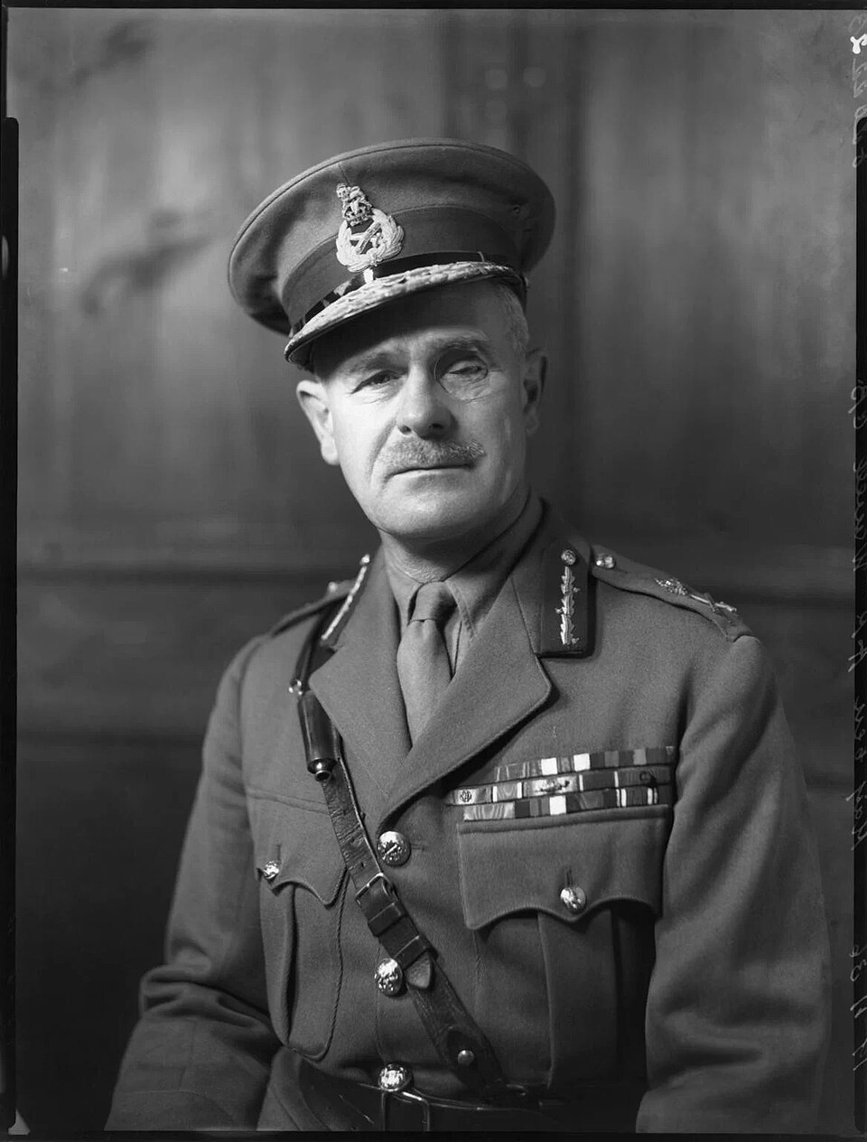 Black-and-white studio portrait of Archibald Wavell in British Army general's uniform and peaked cap, medal ribbons on his chest