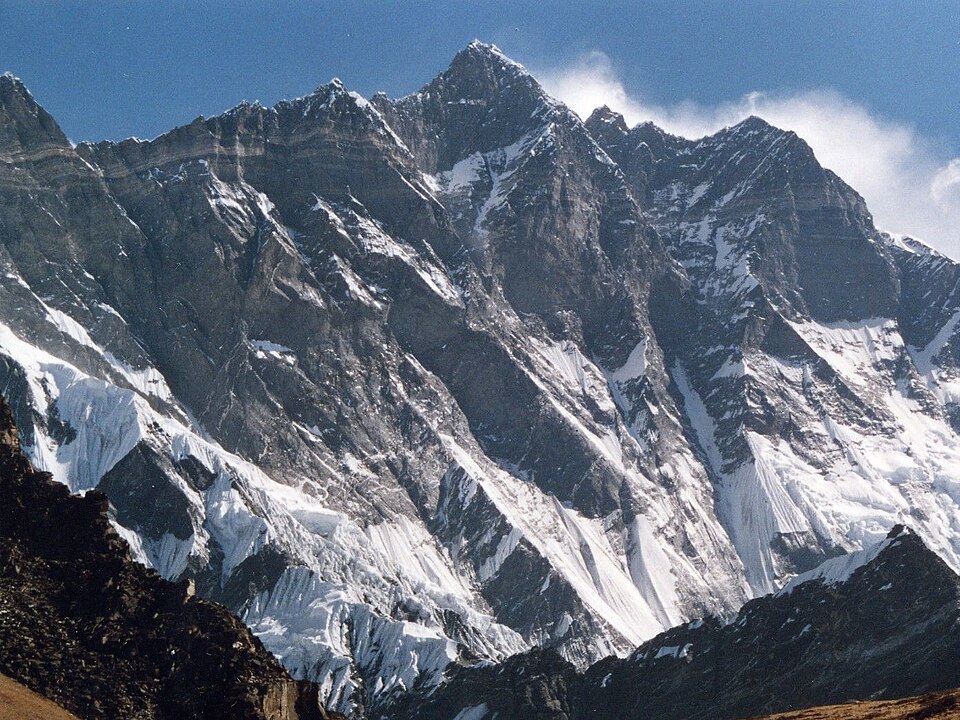 The steep snow-and-rock south face of Lhotse rising to its summit ridge, seen across a glaciated valley from Chhukhung Ri